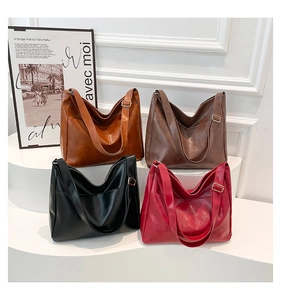 Detail view of four large leather tote bags in caramel, dark coffee, black, and burgundy