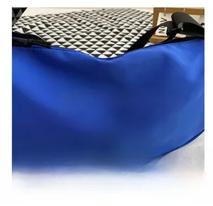 Close-up of blue crescent shoulder bag featuring bold white FASHION BAGS text print