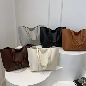 Detailed collection of minimalist large tote bags in five neutral colors on a display