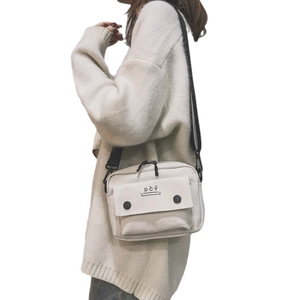 Minimalist white canvas crossbody bag with DCY logo and black adjustable strap for women