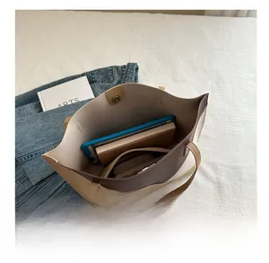 Spacious tote bag interior showing capacity for tablet and notebook with magnetic closure