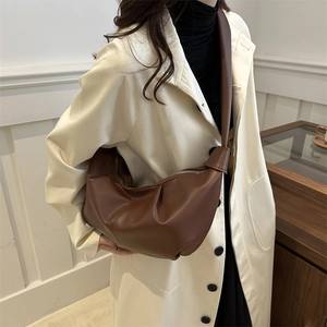 Retro dark brown pebbled leather croissant bag with knotted strap and half-moon design