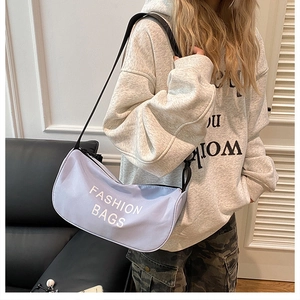 Detail view of light purple crescent crossbody bag with white Fashion Bags text print