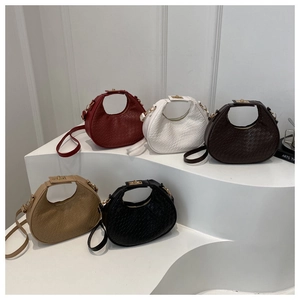 Multi-color hobo bags set in woven texture with gold twist locks on white stairs