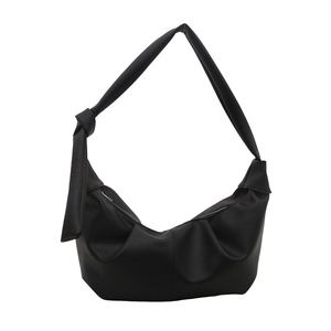 Minimalist black crescent shoulder bag in lychee pattern leather with knot detail
