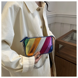 Detail of colorful rainbow metallic stripes on handbag with silver studs and chain