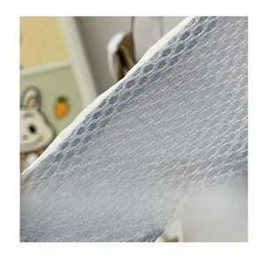 Detail of grey honeycomb mesh breathable shoulder strap with white reinforced edge