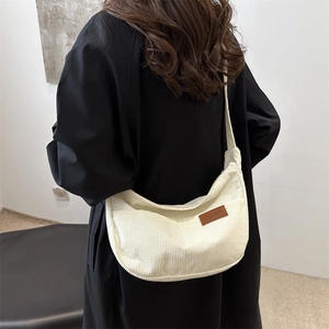 Minimalist beige corduroy hobo bag for women with a fashionable crossbody strap design