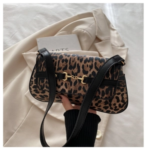 Detail of vintage leopard print shoulder bag featuring gold horsebit metal hardware