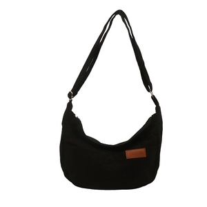 Minimalist black corduroy crescent crossbody bag with adjustable shoulder strap