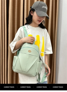 Asian model wearing a mint green water-resistant nylon backpack for school and travel