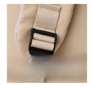 Close-up of adjustable beige nylon shoulder strap and black plastic buckle detail