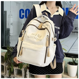 Detail of white canvas backpack with multi-pocket design and Korean casual style
