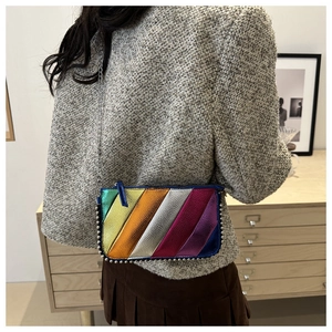 Detail showing rainbow metallic leather patchwork with silver stud edges and chain strap