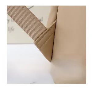 Detail showing triangular reinforced stitching on backpack straps for extra durability