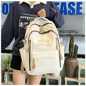 Detail view of white large capacity backpack with side pockets and durable fabric texture