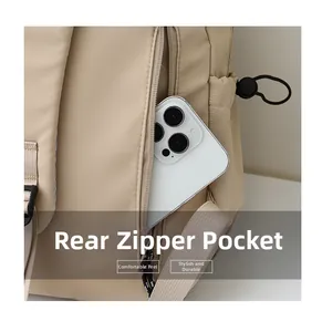 Detail of water-resistant beige backpack featuring a secure anti-theft back zipper pocket