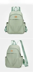 Detail of light green waterproof nylon backpack showing side pockets and textured fabric