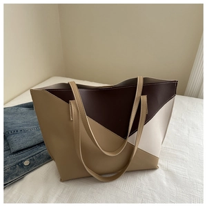 Detail of large capacity color-block tote bag with geometric brown and beige patchwork