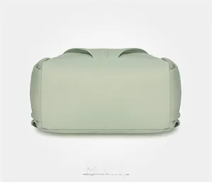 Detailed bottom view of light green water-resistant nylon backpack with reinforced seams