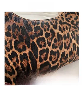 Close-up of leopard print PU leather texture with fine stitching on an underarm bag