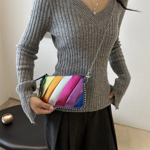 Rainbow striped metallic chain crossbody bag with silver rivets on model