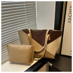 Detail of minimalist tri-color tote bag with matching pouch and matte leather texture