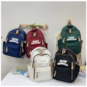 Detailed display of casual student backpacks in blue, red, green, white, and black colors