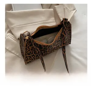 Detailed interior capacity showing leopard print baguette bag with daily essentials