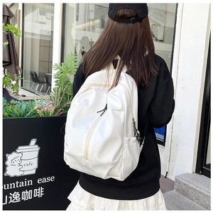 Outdoor shot of the large white nylon backpack showing comfortable shoulder straps and side pocket