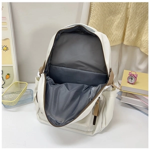 Internal view of a white laptop backpack showing large main compartment and grey lining