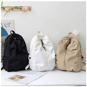 Front view of stylish pleated backpacks in black, white, and khaki for school and travel