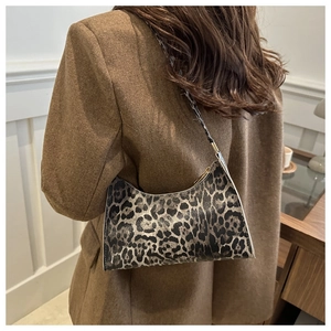 Detail shot of the vintage leopard print underarm bag with gold metal zipper closure