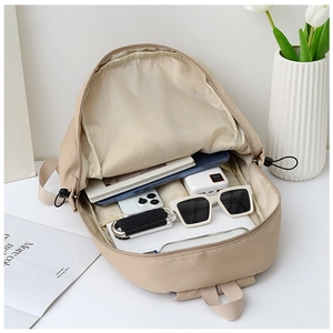 Internal compartment of large beige nylon backpack showing organized storage space