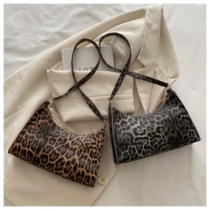 Detail view of leopard print shoulder bags in brown and grey tones on stylish blazer