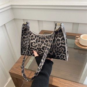 Chic leopard print underarm bag for women featuring a sleek curved silhouette and gold hardware