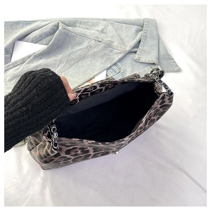 Gros plan du sac léopard avec bandoulière chaîne et intérieur spacieux en tissu noir