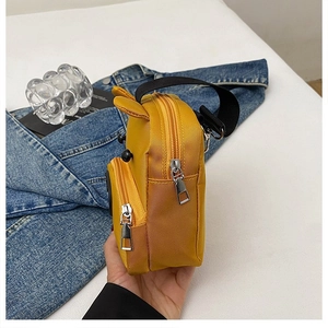 Close-up of yellow cartoon animal backpack with 3D ears and textured fabric details
