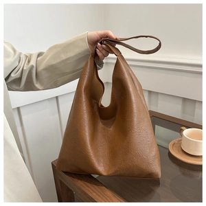 Detail shot of vintage dark brown tote bag with unique pleated texture for daily commute