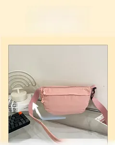 Detailed view of adjustable pink canvas crossbody bag with reinforced shoulder strap webbing