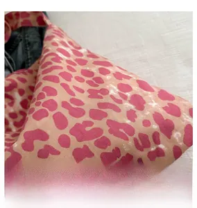 Close-up of pink and brown leopard print pattern on thick canvas shoulder bag fabric