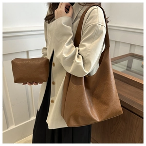Detailed close-up of retro caramel tote bag showing matte texture and matching clutch