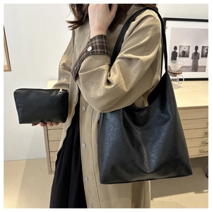 Detailed view of black retro tote bag set with matching inner pouch on a model