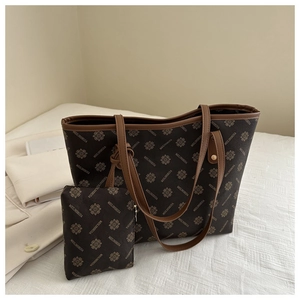 Detail view of the large tote bag set with a matching pouch and monogram pattern