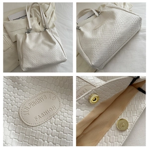 Detail view of woven cream tote bag showing magnetic gold clasp and quilted texture
