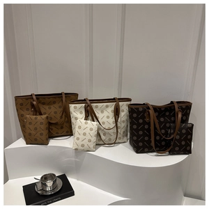 Three elegant leather tote bags with matching zipper pouches shown on white display steps