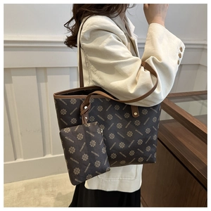 Detail of large tote bag and matching pouch set with dark brown pattern and leather trim