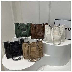Detail showing five colors of quilted pattern tote bags with elegant chain straps