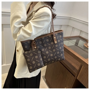 Detail of monogram tote bag with matching pouch and slim shoulder straps