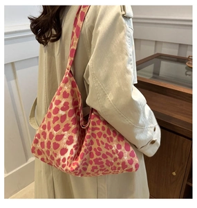 Detail view of pink leopard print canvas tote bag styled with a beige trench coat